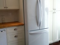 Oak Counter Custom Kitchen with tile backsplash and new fridge